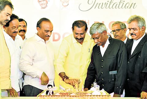 TDP State president Palla Srinivasa Rao cuts the cake as partymen celebrate the birthday of IT Minister Nara Lokesh near High Court in Nelapadu on Friday 
