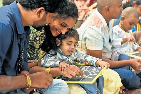 Devotees perform Aksharabyasam ritual on the occasion of Vasanta Panchami at Trishakti Peetham in Vijayawada on Friday.