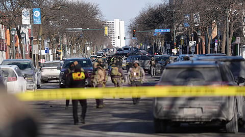 Federal agents stand near the site of a shooting Saturday, Jan. 24, 2026, in Minneapolis.