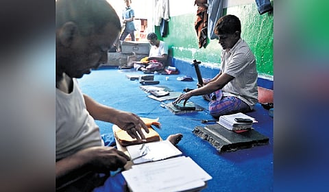 Silver waraq makers at a shop in the Old City of Hyderabad.