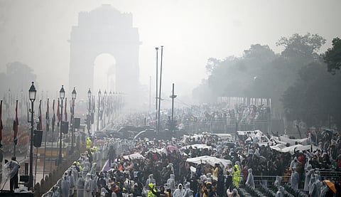 People watching R-Day rehearsal take cover in the Friday rain