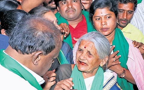 Union Minister HD Kumaraswamy interacts with farmers who are protesting against land acquisition for the Bidadi township project, on Sunday 
