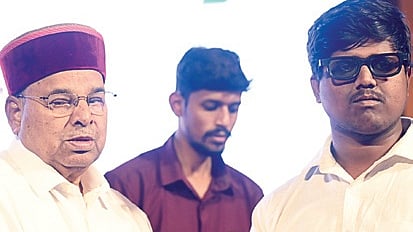 Governor Thaawarchand Gehlot hands out voter ID to a physically challenged youth on National Voters’ Day in Bengaluru on Sunday 