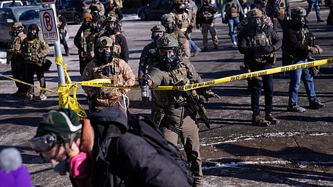 Federal immigration officers deploy pepper spray at protesters after a shooting Saturday, Jan. 24, 2026, in Minneapolis.