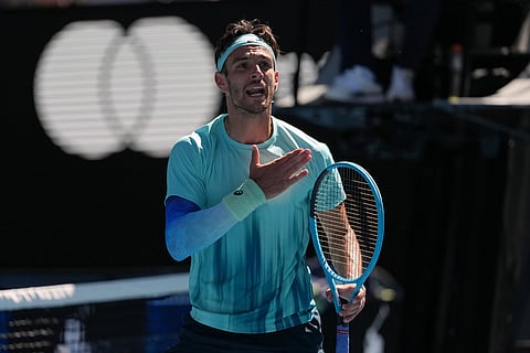 Lorenzo Musetti of Italy reacts as he plays against Taylor Fritz of the U.S. during their fourth round match at the Australian Open tennis championship in Melbourne, Australia, Monday, Jan. 26, 2026.