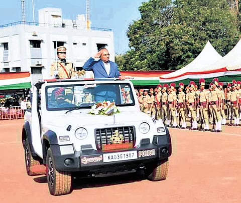 Mangaluru District In-charge Minister Dinesh Gundu Rao receives the guard 
of honour on Monday 