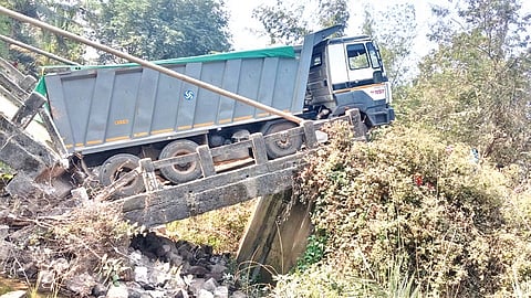 Tipper truck stuck on the collapsed bridge at Torasingha on Sunday.