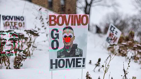 A poster reading "Bovino Go Home", featuring an altered image of US Border Patrol Cmdr Gregory Bovino, is displayed in the snow outside a home on Wednesday, Jan. 21, 2026, in Minneapolis.