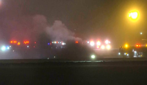 This image taken from video provided by WABI television, emergency services work on a scene of the Bombardier Challenger 600 crash at the Bangor Airport in Maine, late Sunday, Jan. 25, 2026.