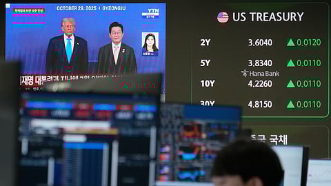 U.S. President Donald Trump, left, and South Korean President Lee Jae Myung are seen on a screen at the foreign exchange dealing room of the Hana Bank headquarters in Seoul, South Korea, Tuesday, Jan. 27, 2026.