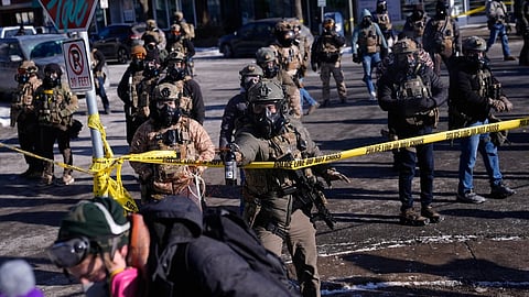 Federal immigration officers deploy pepper spray at protesters after a shooting Saturday, Jan. 24, 2026, in Minneapolis.