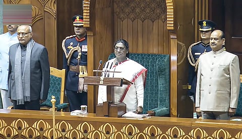 President Droupadi Murmu stands for the national anthem before addressing the Parliament on Wednesday, January 28, 2026.