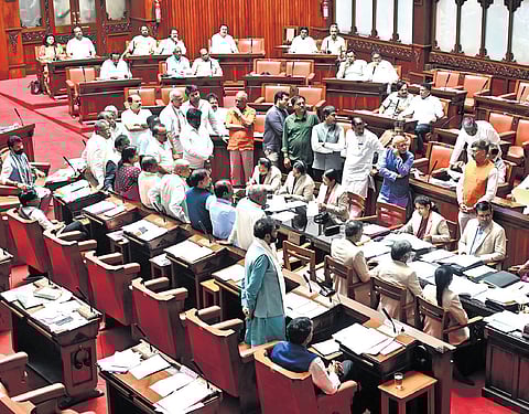 Opposition members protest in the well of the Council during the session in Vidhana Soudha on Wednesday  