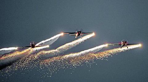 The silence broke unexpectedly when the red-and-white Hawk Mk-132 jets of the Surya Kiran team appeared overhead. 