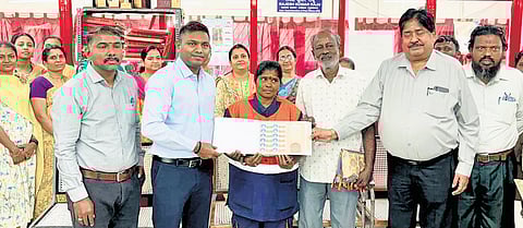 Padma with the personalised postal stamp during a felicitation event.