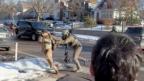 This image taken from video by Max Shapiro shows Alex Pretti, left, scuffling with federal immigration officers in Minneapolis on Jan. 13, 2026. 