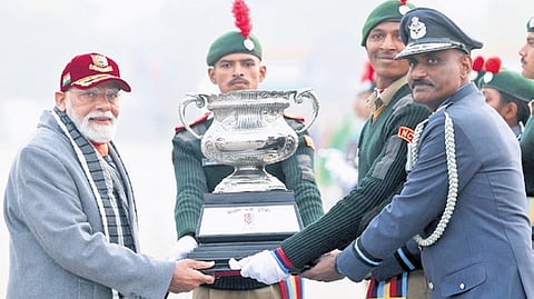 Air Commodore SB Arunkumar receives the trophy from the Prime Minister on Wednesday.