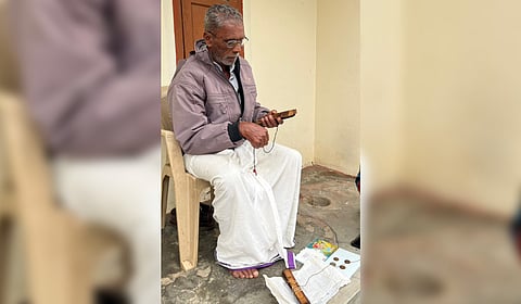 Gunasekharan reads the herbal medicines written in the palm leaf manuscript he treasures for decades.