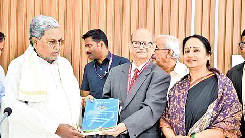 Prof M Govinda Rao, chairman of High Power Committee on Redressal of Regional Imbalance, submits the final report to CM Siddaramaiah in Bengaluru on Saturday 