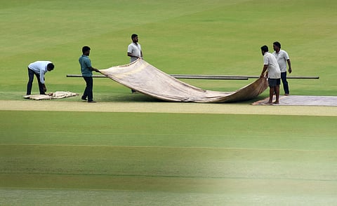 Ground staff working on the pitch at the MA Chidambaram Stadium