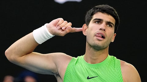 Carlos Alcaraz of Spain reacts during his semifinal match against Alexander Zverev of Germany at the Australian Open tennis championship in Melbourne, Australia, Friday, Jan. 30, 2026. 