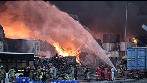 Firefighters try to extinguish the fire,after a massive explosion and fire rocked a port near the southern port city of Bandar Abbas, Iran, on Saturday, January 31, 2026 