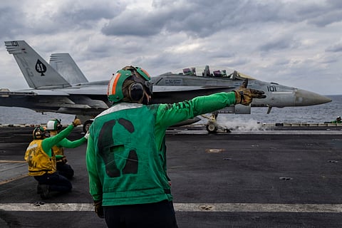 In this handout photo released by the US Navy on January 31, 2026, an F/A-18F Super Hornet attached to Strike Fighter Squadron (VFA) 41 prepares to launch from the flight deck of the Nimitz-class aircraft carrier USS Abraham Lincoln (CVN-72) as it conducts routine flight operations in the Arabian Sea on January 28, 2026.