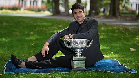 Carlos Alcaraz of Spain poses with the Norman Brookes Challenge Cup the morning after defeating Novak Djokovic of Serbia in the men's singles final at the Australian Open tennis championship, in Melbourne, Australia, Monday, Feb. 2, 2026.