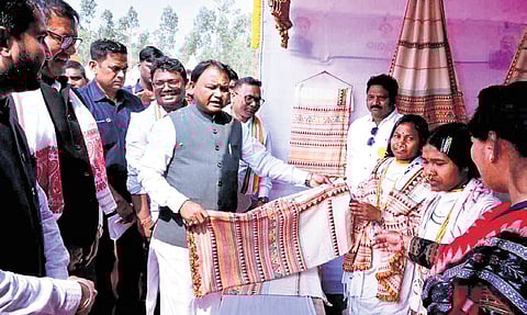 CM Mohan Charan Majhi checking out a shawl at the Subhadra Shakti Mela. 