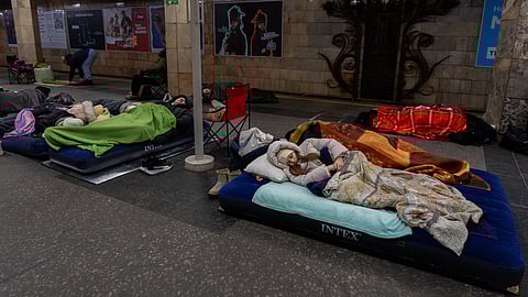 People take shelter in a metro station, being used as a bomb shelter, during a Russian drones attack in Kyiv, Ukraine, Tuesday, Feb. 3, 2026.