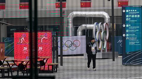 A person walks in the Olympic Village at the 2026 Winter Olympics, in Milan, Italy, Friday, Jan. 30, 2026.