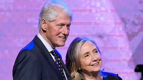 Former President Bill Clinton, left, and former Secretary of State Hillary Clinton listen as Vice President Kamala Harris delivers a eulogy for U.S. Rep. Sheila Jackson Lee, Aug. 1, 2024, in Houston. 