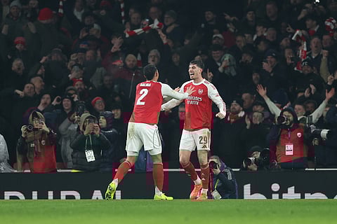 Arsenal's Kai Havertz, right, celebrates with Arsenal's William Saliba after scoring the opening goal during the English League Cup semifinal second leg soccer match between Arsenal and Chelsea in London, Tuesday, Feb. 3, 2026. 