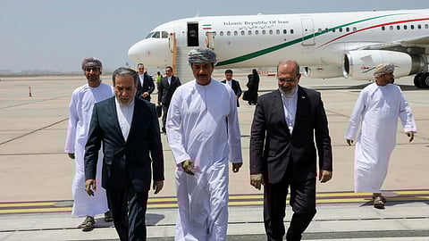 FILE - In this photo released by the Iranian Foreign Ministry, Iranian Foreign Minister Abbas Araghchi, left, is welcomed by an unidentified Omani official, center, upon his arrival at Muscat, Oman, for negotiations with U.S. Mideast envoy Steve Witkoff, as Iranian Ambassador to Oman Mousa Farhang walks at right, May 11, 2025.
