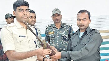 Sukhram Markam surrendering his firearm