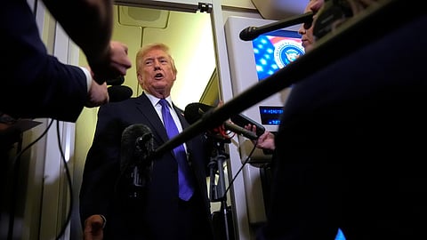 US President Donald Trump speaks to reporters as he flies aboard Air Force One from Joint Base Andrews, Md., to West Palm Beach, Fla., Friday, Feb. 6, 2026.