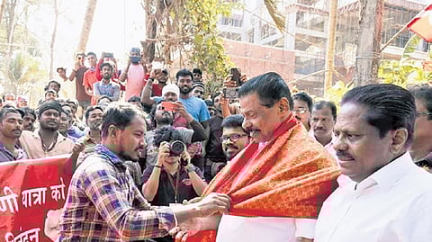 A migrant worker honours CPM state gen secy M V Govindan with a shawl during the Vikasana Munnetta Jatha in Kannur