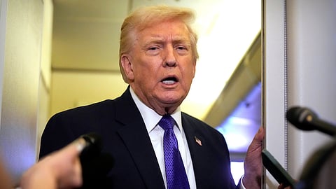 US President Donald Trump speaks to reporters as he flies aboard Air Force One from Joint Base Andrews, Md., to West Palm Beach, Fla., Friday, Feb. 6, 2026.