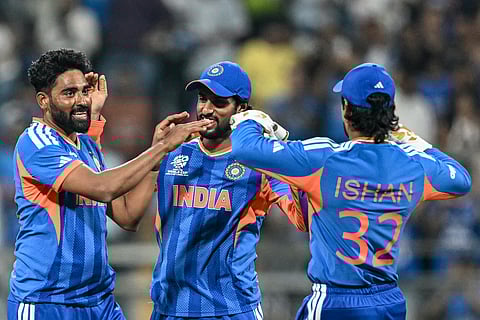 India's Mohammed Siraj (L) celebrates with teammates after taking the wicket of USA's Saiteja Mukkamalla during the 2026 ICC Men's T20 Cricket World Cup at the Wankhede Stadium in Mumbai.