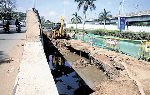 Metro Water workers repairing a caved in road near old Roja Muthiah Research Library on Rajiv Gandhi Salai.
