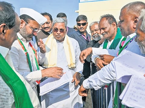 Chief Minister Siddaramaiah interacts with farmers after inaugurating various projects at Shiraguppi village on Sunday.