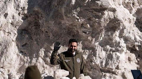 New York City Mayor Zohran Mamdani waves at supporters during a visit to the Department of Sanitation's snow melting operations in New York