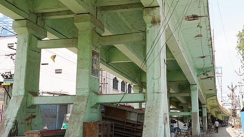 The side wall of the South Gate bridge lies severely damaged, with vegetation growing beneath it, leaving it in a pathetic condition.