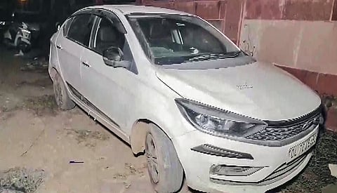 A view of the car in which three bodies, of two men and one woman, were found earlier today at the Peeragarhi flyover, in New Delhi on Sunday.