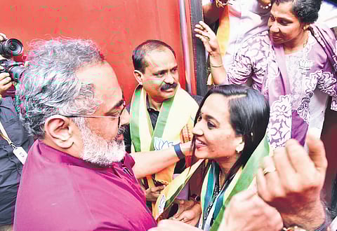 BJP state president Rajeev Chandrasekhar receives Thiruvananthapuram Mayor V V Rajesh and Deputy Mayor Asha Nath, who are travelling to New Delhi on an invite from the prime minister, at Ernakulam Town railway station.