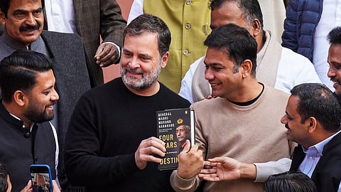 Leader of Opposition in the Lok Sabha Rahul Rahul Gandhi shows a copy of the unpublished memoir of former Army chief M M Naravane outside the Parliament