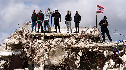 People gather as Lebanese Prime Minister Nawaf Salam tours areas in southern Lebanon along the border with Israel that the Lebanese army says it has been cleared of the armed presence of the militant Hezbollah group, in the village of Yarine, Saturday, Feb. 7, 2026.