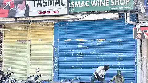 People waiting outside a Tasmac outlet in Triplicane, Chennai, while it was closed from 12 pm to 3 pm on Monday due to a protest by employees