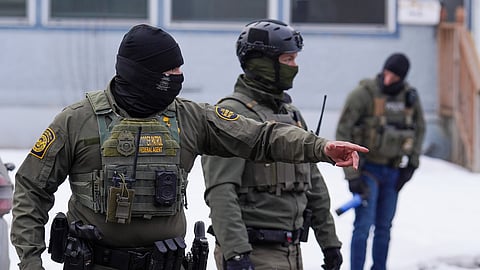 A United States Border Patrol agent gestures to a car while conducting immigration enforcement operations, Thursday, Feb. 5, 2026, in Minneapolis