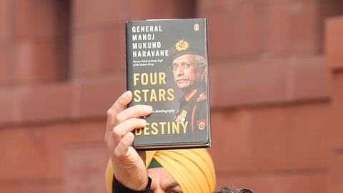 Leader of Opposition in the Lok Sabha Rahul Gandhi shows a copy of the unpublished memoir of ormer Army chief General Manoj Mukund Naravane's during Budget Session of Parliament.